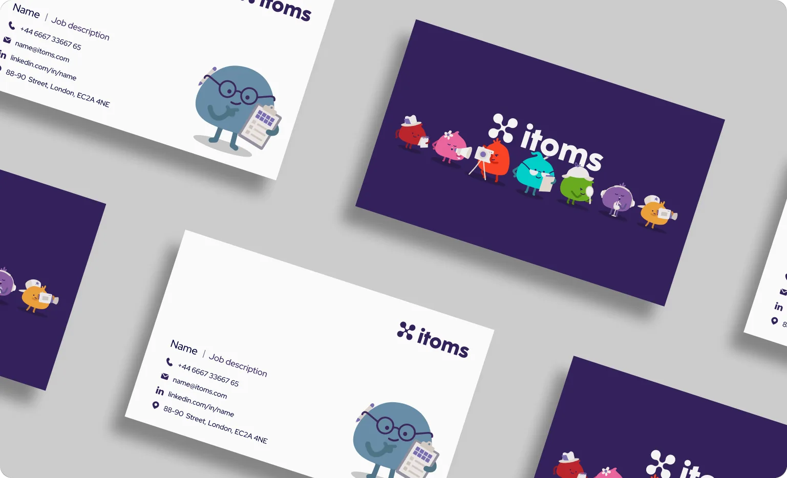 itoms business cards scattered on a grey surface, backs lining up the full cast of characters